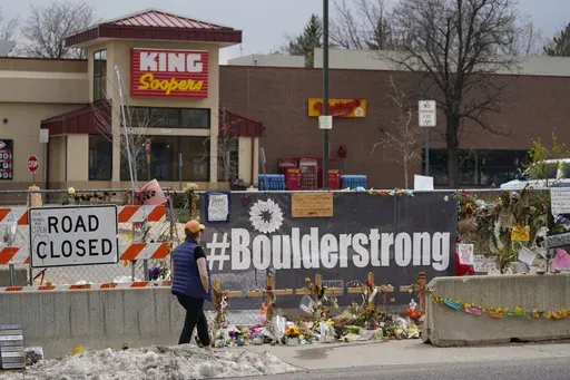 Tributes cover the temporary fence around the King Soopers grocery store in which 10 people died in a mass shooting in late March on Friday, April 23, 2021, in Boulder, Colo. (AP Photo/David Zalubowski, File)