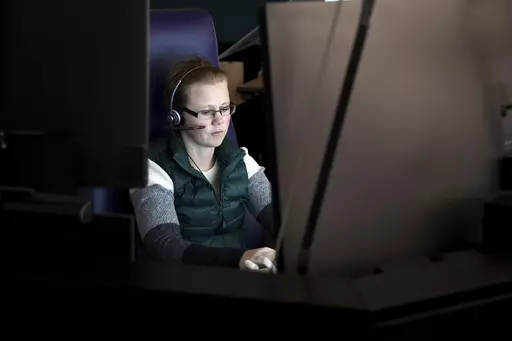 911 dispatch trainee Loren Bengston works at a computer in Denver on Thursday, Oct. 20, 2022. The city's STAR program uses clinicians and EMTs or paramedics to respond to nonviolent mental health crises, instead of police. Data gathered by The Associated Press show at least 14 of the 20 most populous U.S. cities are hosting or starting such programs, sometimes called civilian, alternative or non-police response teams. They span from New York and Los Angeles to Columbus, Ohio, and Houston, and bo