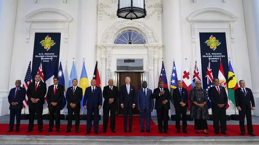 President Joe Biden, center, poses for a photo with Pacific Island leaders on the North Portico of the White House in Washington, Sept. 29, 2022. From left, New Caledonia President Louis Mapou, Tonga Prime Minister Siaosi Sovaleni, Palau President Surangel Whipps Jr., Tuvalu Prime Minister Kausea Natano, Micronesia President David Panuelo, Fiji Prime Minister Josaia Voreqe Bainimarama, Biden, Solomon Islands Prime Minister Manasseh Sogavare, Papua New Guinea Prime Minister James Marape, Marshall