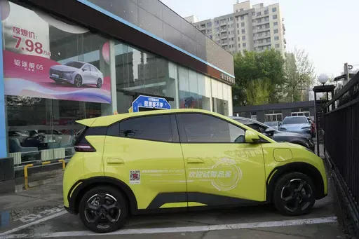 A Seagull electric vehicle from Chinese automaker BYD for test driving is parked outside a showroom in Beijing, Wednesday, April 10, 2024. The tiny, low-priced electric vehicle called the Seagull has American automakers and politicians trembling. The car, launched last year by Chinese automaker BYD, sells for around $12,000 in China. But it drives well and is put together with craftsmanship that rivals U.S.-made electric vehicles that cost three times as much. Tariffs on imported Chinese vehicle