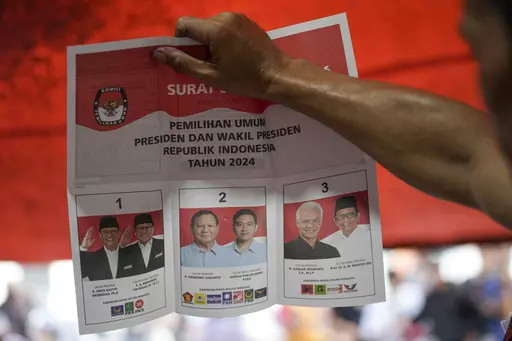 An electoral worker holds up a ballot showing a vote for presidential candidate Prabowo Subianto and his running mate Gibran Rakabuming Raka, the eldest son of Indonesian President Joko Widodo, during the vote counting at a polling station following the election in Jakarta, Indonesia, Wednesday, Feb. 14, 2024. The camps of the two presidential candidates who appear to have lost in Indonesia's election last month said Thursday they plan to challenge the results in the Constitutional Court with al