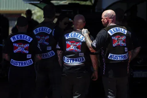 Mourners gather at a funeral parlor in north Perth, Australia before riding to the funeral of murdered Rebels biker Nick Martin at Pinnaroo Cemetery in Perth, Australia, on Wednesday, Dec. 23, 2020. The former Rebels president was gunned down earlier in the month at the Perth Motorplex. Martin’s murder left police a trove of evidence that led them to the culprit. But they wanted more. The coronavirus pandemic provided it in the form of an electronic dragnet: QR code check-in data from contact 