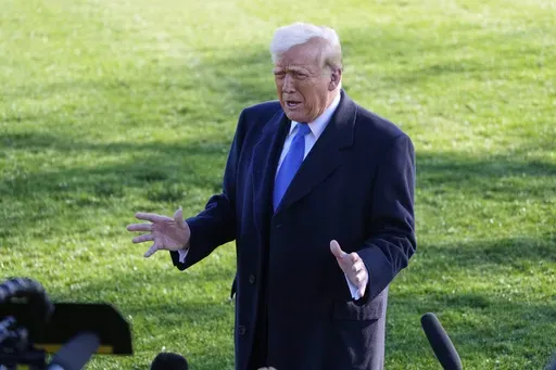 President Donald Trump speaks with reporters before departing on Marine One en route to New Jersey, Friday, Mar. 21, 2025, in Washington. (AP Photo/Mark Schiefelbein)
