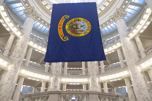 The Idaho state flag hangs in the State Capitol in Boise, Idaho, Jan. 9, 2023. The Idaho Senate is expected to take a final vote on Monday, March 18, 2024, on a bill that would prohibit transgender and nonbinary Idahoans enrolled in Medicaid, or state employees enrolled in the state's insurance plan, from obtaining gender-affirming care. (AP Photo/Kyle Green, File)