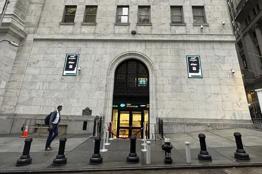 A man approaches an entrance to the New York Stock Exchange on Sept. 26, 2024, in New York. (AP Photo/Peter Morgan, File)