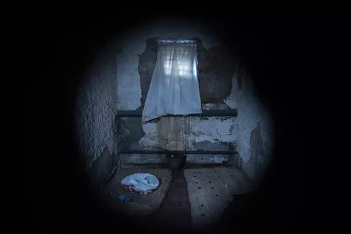 Mattresses lie on the floor in a holding cell at the basement of a police station which was used by Russian forces in the recently liberated town of Izium, Ukraine, Thursday, Sept. 22, 2022. Based on accounts of survivors and police, Associated Press journalists located 10 torture sites in the town and gained access to five of them including the police station. (AP Photo/Evgeniy Maloletka)