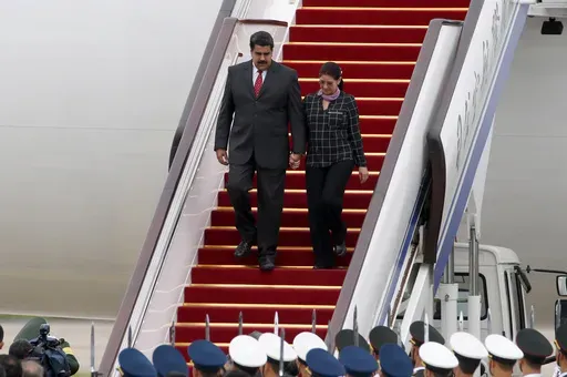 Venezuela's President Nicolas Maduro, left, and first lady Cilia Flores arrive at Beijing Capital International Airport in Beijing, China, Sept. 1, 2015. (AP Photo/Ng Han Guan, File)