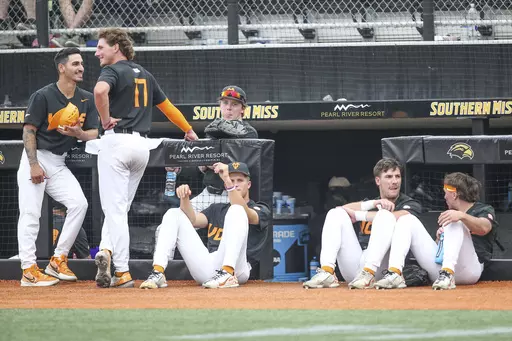 Tennessee players relax during a lightning delay during an NCAA college baseball tournament super regional game against Southern Mississippi in Hattiesburg, Miss., Saturday, June 10, 2023. (James Pugh/impact601.com via AP)