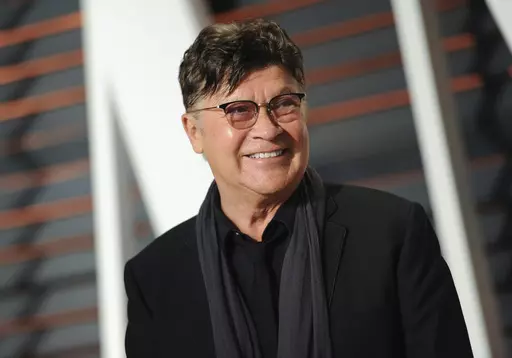Musician Robbie Robertson arrives at the Vanity Fair Oscar Party on Sunday, Feb. 22, 2015, in Beverly Hills, Calif. Robertson, the lead guitarist and songwriter for The Band, whose classics include “The Weight,” “Up on Cripple Creek” and “The Night They Drove Old Dixie Down,” has died at 80, according to a statement from his manager. (Photo by Evan Agostini/Invision/AP, File)