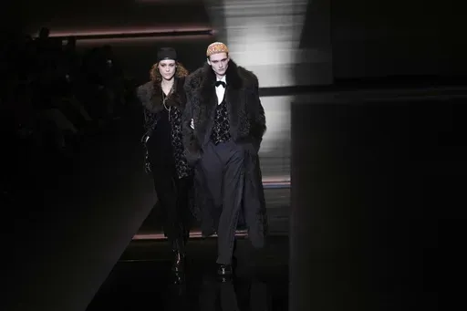 Models wear creations part of the men's Emporio Armani Fall-Winter 2025-2026 collection, that was presented in Milan, Italy, Saturday, Jan. 18, 2025. (AP Photo/Antonio Calanni)