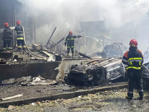 In this photo provided by the Ukrainian Emergency Service, firefighters work to extinguish fire at a building damaged by shelling, in Vinnytsia, Ukraine, Thursday, July 14, 2022. (Ukrainian Emergency Service via AP)