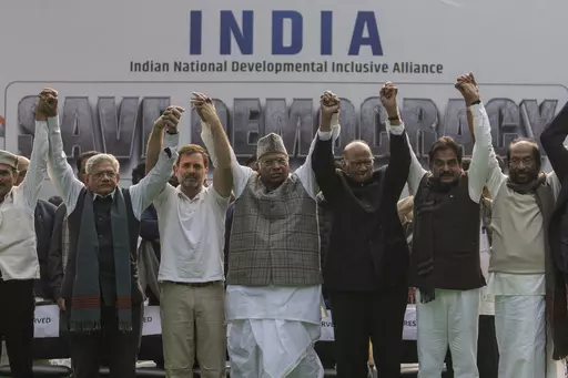 FILE- Leaders from the opposition INDIA alliance raise their hands together in a show of unity during a protest rally against the suspension of more than 140 lawmakers from the parliament, in New Delhi, India, Dec. 22, 2023. Last year more than two dozen opposition parties in India came together to take on Narendra Modi, one of the country's most popular prime ministers in generations. But the broad alliance, beset with ideological differences and personality clashes, is cracking at a crucial ti