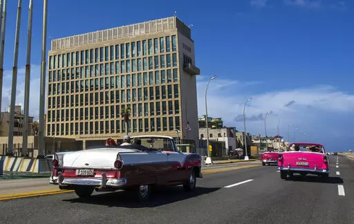 Tourists ride classic convertible cars on the Malecon beside the United States Embassy in Havana, Cuba, Oct. 3, 2017. U.S. intelligence agencies cannot link a foreign adversary to any of the incidents associated with so-called “Havana syndrome,” the hundreds of cases of brain injuries and other symptoms reported by American personnel around the world. The findings released Wednesday by American intelligence officials cast doubt on the longstanding suspicions by many people who reported cases