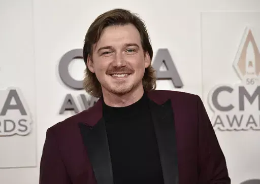 Morgan Wallen arrives at the 56th annual CMA Awards, Nov. 9, 2022, in Nashville, Tenn. On Tuesday, May 21, 2024, Nashville councilmembers rejected plans for a glowing sign at Wallen's new bar along the city's neon-lit strip of honky tonks, citing his use of a racial slur publicized in 2021 and his recent criminal charges of throwing a chair off a rooftop and nearly hitting two police officers. (Photo by Evan Agostini/Invision/AP, File)