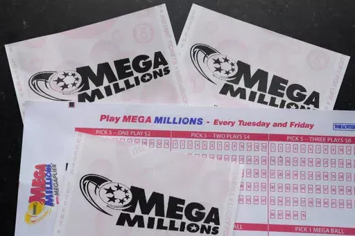 Mega Millions lottery tickets and a wager slip are displayed, Friday, Jan. 6, 2023, in Derry, N.H. An estimated $1.1 billion Mega Millions jackpot drawing Tuesday, Jan. 10, 2023, has people lined up at convenience stores nationwide to buy tickets in longshot hopes of winning a massive prize, but shop and gas station owners selling the tickets also have a chance at a big-figure bonus. (AP Photo/Charles Krupa, File)