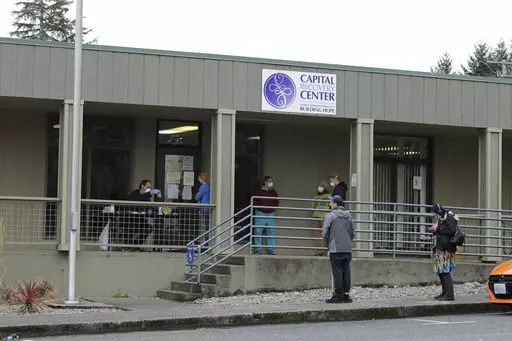 Patients line up to pick up medication for opioid addiction at a clinic in Olympia, Wash., on March 27, 2020. (AP Photo/Ted S. Warren, File)