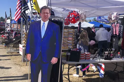 A cardboard cutout of Florida Gov. Ron DeSantis stands in the merchandise area outside former President Donald Trump's rally in Conroe, Texas, Saturday, Jan. 29, 2022. At Trump’s rally, there were signs of change. Next to the Trump hats, shirts and flags sat a collection of Ron “DeSantis 2024” bumper stickers. The vast majority of those interviewed at Trump’s rally enthusiastically cheered the prospect of another Trump run. But there were some who conceded that, perhaps, there might be a