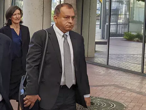 Ramesh "Sunny" Balwani, right, the former lover and business partner of Theranos CEO Elizabeth Holmes, walks into federal court in San Jose, Calif., on June 24, 2022. Balwani learns Wednesday, Dec. 7, 2022, whether he will be punished as severely as Holmes for peddling the company's bogus blood-testing technology that duped investors and endangered patients. (AP Photo/Michael Liedtke, File)
