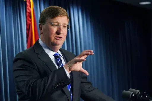 Mississippi Gov. Tate Reeves explains to reporters some of the line items that he vetoed from the appropriations allocated by the state Legislature, Thursday, April 28, 2022, in Jackson, Miss. (AP Photo/Rogelio V. Solis)