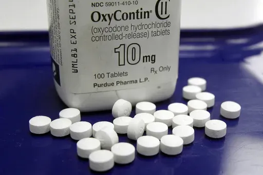 OxyContin pills arranged for a photo at a pharmacy, Feb. 19, 2013 in Montpelier, Vt. (AP Photo/Toby Talbot, File)