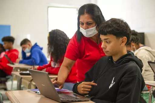 English as a second language teacher Paula Montoya helps student Reinaldo Caraballo with his classwork on Monday, Oct. 25, 2021  in Pascagoula, Miss.  Montoya assists many students whose first language is not English. The Pascagoula-Gautier School District has by far the largest English Learner population of any on the Coast, at about 13% as of May 2021, most of whom are native Spanish speakers. That’s one of the five biggest EL populations in the state, according to data the Sun Herald reques