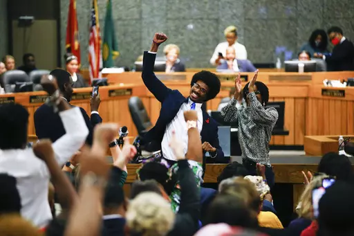 Justin Pearson celebrates with supporters after being reinstated to the Tennessee House of Representatives by the Shelby County Board of Commissioners building in Memphis, Tenn., on Wednesday, April 12, 2023. Republicans expelled Pearson and Rep. Justin Jones last week over their role in a gun control protest on the House floor. (Chris Day/The Commercial Appeal via AP)