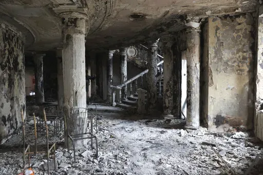 Debris covers the inside of the Donetsk Academic Regional Drama Theatre following a March 16, 2022, bombing in Mariupol, Ukraine, in an area now controlled by Russian forces, Monday, April 4, 2022. The bombing of the theater that was used as a shelter stands out as the single deadliest known attack against civilians to date in the war. (AP Photo/Alexei Alexandrov, File)