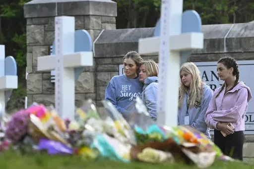 Students at a nearby school pay respects at a memorial for the people who were killed, at an entry to Covenant School, Tuesday, March 28, 2023, in Nashville, Tenn. Six people were killed at the private school and church yesterday by a shooter. The U.S. is setting a record pace for mass killings in 2023, replaying the horror in a deadly loop roughly once a week so far this year. The bloodshed overall represents just a fraction of the deadly violence that occurs in the U.S. annually. (AP Photo/Joh