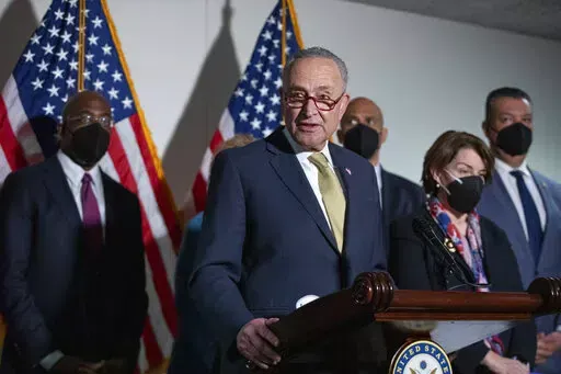 Senate Majority Leader Chuck Schumer, D-N.Y., speaks to reporters alongside, from left, Sen. Raphael Warnock, D-Ga., Sen. Cory Booker, D-N.J., Sen. Amy Klobuchar, D-Minn., and Sen. Alex Padilla, D-Calif., during a press conference regarding the Democratic party's shift to focus on voting rights at the Capitol in Washington, Tuesday, Jan. 18, 2022. (AP Photo/Amanda Andrade-Rhoades)