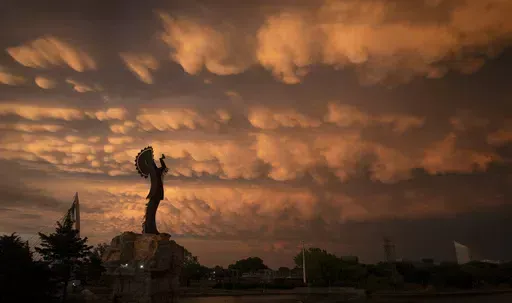 A formation of Mammatus clouds fills the sky over Wichita, Kan., on Tuesday, April 30, 2024. Mammatus clouds usually form on the back side of severe thunderstorms. A line of severe storms crossed the state Tuesday afternoon and evening, including a few tornados in the northeastern part of Kansas. (Travis Heying/The Wichita Eagle via AP)