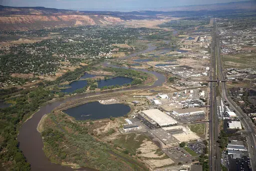 The Colorado River passes through Grand Junction, Aug. 24, 2022, in Mesa County, Colo. California released a plan Tuesday, Jan. 31, 2023, detailing how western states reliant on the Colorado River could save more water, a day after it was the only state that didn't sign a proposal agreed to by six states in the basin. (Hugh Carey/The Colorado Sun via AP, File)