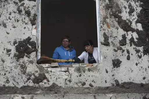 Nurses clean up in the room after a Russian attack on mental hospital №3 in Kharkiv, Ukraine, Saturday, April 27, 2024. (AP Photo/Andrii Marienko)