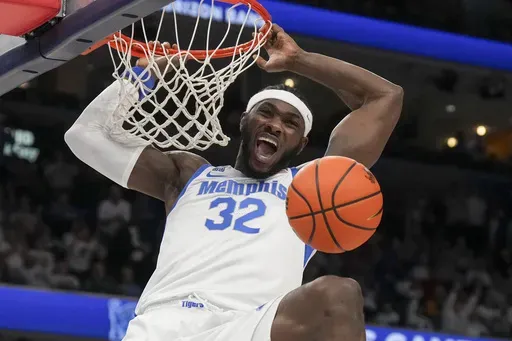 Memphis center Moussa Cisse (32) dunks the ball during the first half of an NCAA college basketball game against Mississippi, Saturday, Dec. 28, 2024, in Memphis, Tenn. (AP Photo/George Walker IV)