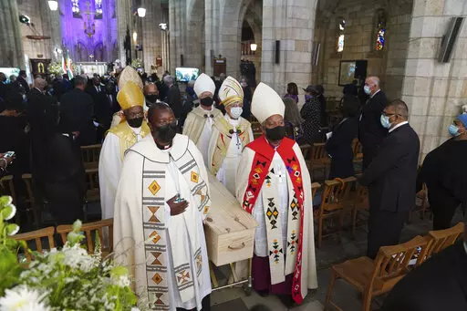 The coffin is carried out of the cathedral at the end of the funeral service for Anglican Archbishop Emeritus Desmond Tutu in St. George's Cathedral in Cape Town, South Africa, Saturday, Jan. 1, 2022. Tutu, the Nobel Peace Prize-winning activist for racial equality and LGBT rights died Sunday at the age of 90. (Nic Bothma/Pool Photo via AP).