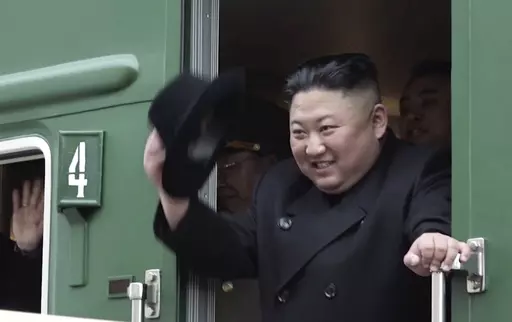 In this image from video released by Primorsky Regional Administration Press Service, North Korean leader Kim Jong Un waves from his train as he leaves Khasan train station in Primorye region, Russia, Wednesday, April 24, 2019. North Korean leader Kim Jong Un’s possible trip to Russia might be like his first one in 2019, a rattling, 20-hour ride aboard a green-and-yellow armored train that is a quirky symbol of his family’s dynastic leadership. (Primorsky Regional Administration Press Servic