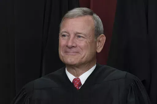 Chief Justice of the United States John Roberts joins other members of the Supreme Court as they pose for a new group portrait, at the Supreme Court building in Washington, Oct. 7, 2022. Roberts has declined an invitation to meet with Democratic senators to talk about Supreme Court ethics and the controversy over flags that flew outside homes owned by Justice Samuel Alito. (AP Photo/J. Scott Applewhite, File)