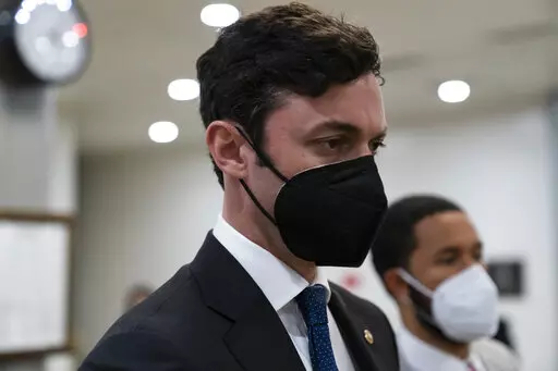 Sen. Jon Ossoff, D-Ga., walks on Capitol Hill, on Oct. 7, 2021, in Washington. Pressure is building for Congress to pass legislation that would curtail lawmakers' ability to speculate on the stock market. Public anger over congressional stock trading has mounted since the first tremors of the pandemic. (AP Photo/Alex Brandon, File)