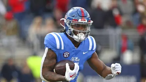 Mississippi running back Quinshon Judkins (4) runs the ball during the first half of an NCAA college football game against Alabama in Oxford, Miss., Saturday, Nov. 12, 2022. (AP Photo/Thomas Graning)