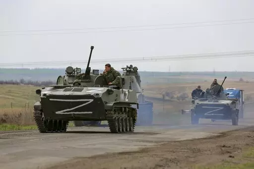 Russian military vehicles move on a highway in an area controlled by Russian-backed separatist forces near Mariupol, Ukraine, April 18, 2022. Mariupol, a strategic port on the Sea of Azov, has been besieged by Russian troops and separatist forces in eastern Ukraine for more than six weeks. (AP Photo/Alexei Alexandrov, File)