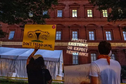 Abortion-rights protesters project messages to a building during an event sponsored by Susan B. Anthony Pro Life America at the National Building Museum, Sept. 13, 2022, in Washington. Emboldened anti-abortion activists are looking to the next presidential election as an opportunity to solidify their influence over the Republican Party. Leaders of the influential group Susan B. Anthony Pro-Life America are telling potential GOP presidential hopefuls they expect Republican candidates to support n