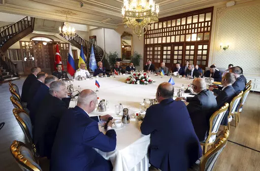 In this handout photo provided by the Turkish Defence Ministry, Russian, left, and Ukranian, top right, delegations meet along with United Nation observers, right, and Turkish Defence Ministry members in Istanbul, Turkey, Wednesday, July 13, 2022. Military delegations from Russia and Ukraine held their governments' first face-to-face talks in months Wednesday as they tried to reach an agreement on a United Nations plan to export blocked Ukrainian grain to world markets through the Black Sea. (Tu