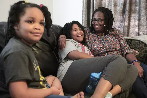 Deleah Payne, 12, center, spends time with her mother Delisa, right, and 6-year-old sister Delynn, left, as they watch movie clips on their living room television in Evansville, Ind., Tuesday evening, Aug. 27, 2019. Deleah and Delynn were both diagnosed with autism. For the first time, autism is being diagnosed more frequently in Black and Hispanic children than in white kids in the U.S., the Centers for Disease Control and Prevention said Thursday, March 23, 2023. (Sam Owens/Evansville Courier 