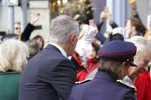 A protester, top left, throws eggs at King Charles III, right, and the Queen Consort, left, as they arrive for  a ceremony at Micklegate Bar, where the Sovereign is traditionally welcomed to the city, in York, England, Wednesday Nov. 9, 2022. (Jacob King/PA via AP)