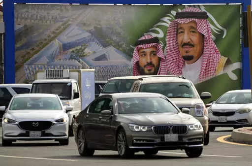 A giant banner showing Saudi King Salman, right, and Crown Prince Mohammed bin Salman, is displayed prior to a visit by U. S. President Joe Biden, in a square in Jeddah, Saudi Arabia, Thursday, July 14, 2022. (AP Photo/Amr Nabil)