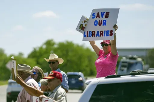 Llano resident Emily Decker protests outside a Llano County Commissioner's Court meeting at the Llano County Law Enforcement Center, April 13, 2023, in Llano, Texas. A federal appeals court in New Orleans is taking another look at its own order requiring Llano County, Texas, to keep eight books on public library shelves that deal with subjects including sex, gender identity and racism. County officials had removed over a dozen books from its shelves amid complaints about the subject matter. (Aar