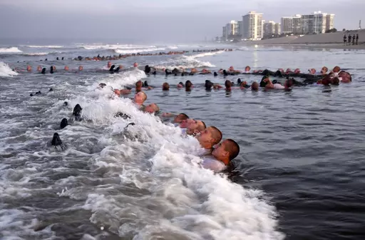 U.S. Navy SEAL candidates, participate in "surf immersion" during Basic Underwater Demolition/SEAL (BUD/S) training at the Naval Special Warfare (NSW) Center in Coronado, Calif., on May 4, 2020. The training program for Navy SEALs is plagued by widespread medical failures, poor oversight and the use of performance enhancing drugs that have increased the risk of injury and death to candidates seeking to become an elite commando, according to a highly critical new investigation triggered by the de