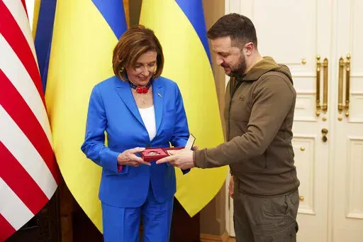 In this image released by the Ukrainian Presidential Press Office on Sunday, May 1, 2022, Ukrainian President Volodymyr Zelenskyy, right, awards the Order of Princess Olga, the third grade, to U.S. Speaker of the House Nancy Pelosi in Kyiv, Ukraine, Saturday, April 30, 2022. Pelosi, second in line to the presidency after the vice president, is the highest-ranking American leader to visit Ukraine since the start of the war, and her visit marks a major show of continuing support for the country's 