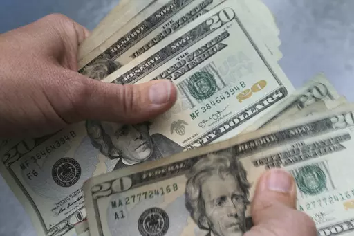 In this June 15, 2018 file photo, twenty dollar bills are counted in North Andover, Mass. GoodRx’s prescription savings program offers significant discounts on prescription drugs, but not without some catches. Using GoodRx means paying out of pocket, without insurance. The cost doesn’t count toward your deductible. (AP Photo/Elise Amendola, File)