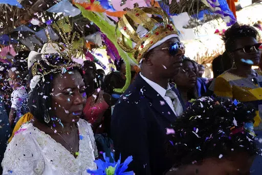 Adonildes da Cunha, right, Emperor, and Nilda dos Santos, left, Queen, arrive for a celebration after a Mass in the chapel of the Kalunga quilombo, during the culmination of the week-long pilgrimage and celebration for the patron saint "Nossa Senhora da Abadia" or Our Lady of Abadia, in the rural area of Cavalcante in Goias state, Brazil, Monday, Aug. 15, 2022. Devotees, who are the descendants of runaway slaves, celebrate Our Lady of Abadia at this time of the year with weddings, baptisms and b