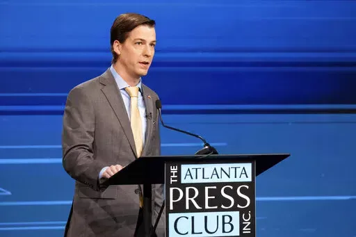 Libertarian challenger Chase Oliver speaks at a U.S. Senate debate with U.S. Sen. Raphael Warnock, D-Ga., during the Atlanta Press Club Loudermilk-Young Debate Series in Atlanta on Sunday, Oct. 16, 2022. Republican challenger Herschel Walker was invited but did not attend. (AP Photo/Ben Gray)